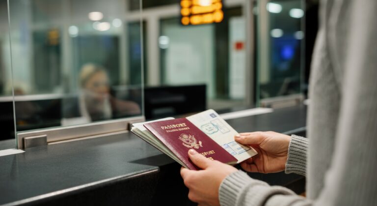 person holding passport at airport immigration counter